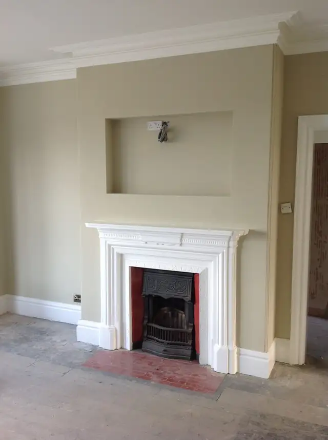 Living room in Southport with cream walls, a white fire surround and decorative cornice